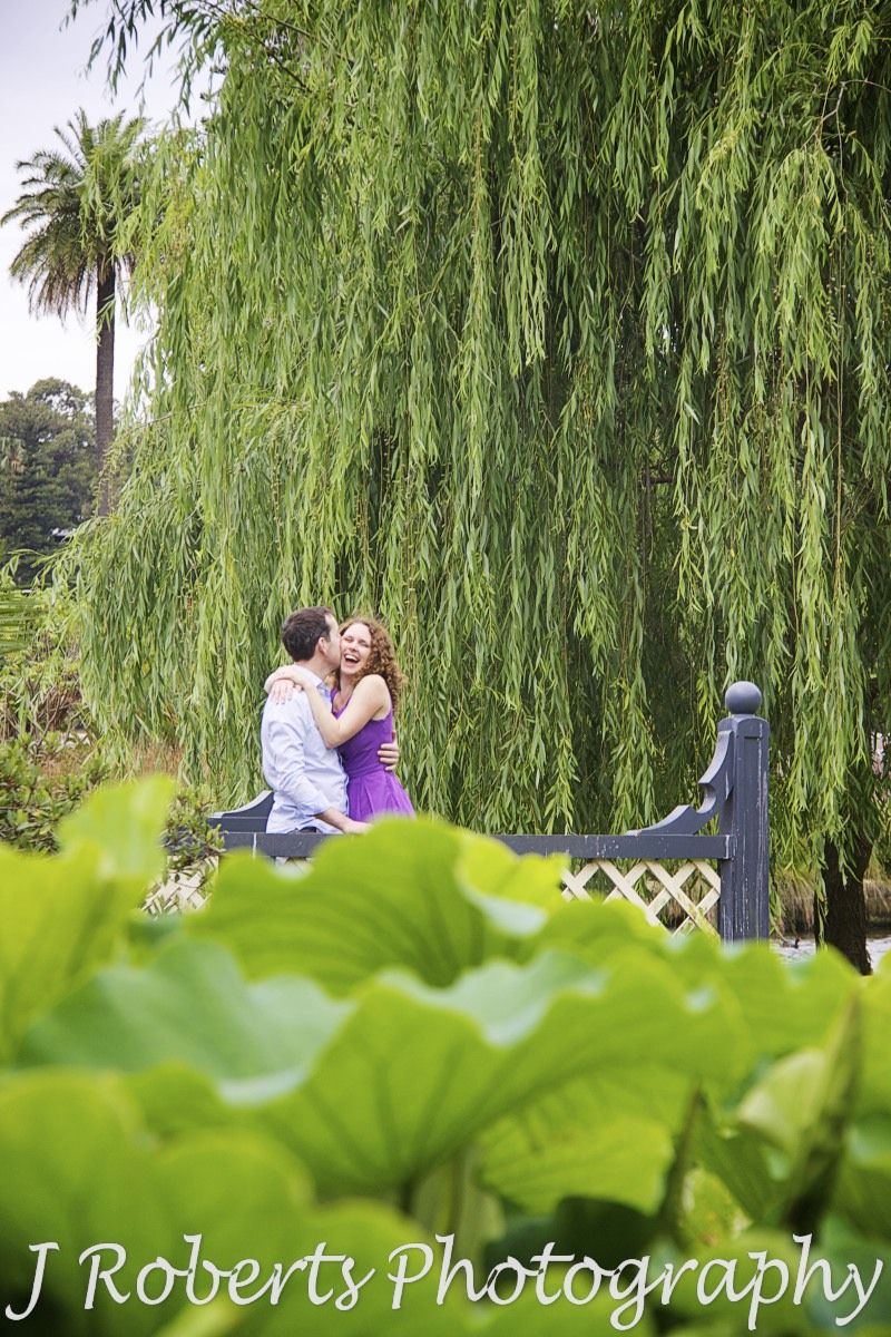 Couple embracing near the lilly ponds at Royal Botanic Gardens Sydney - engagement photography sydney